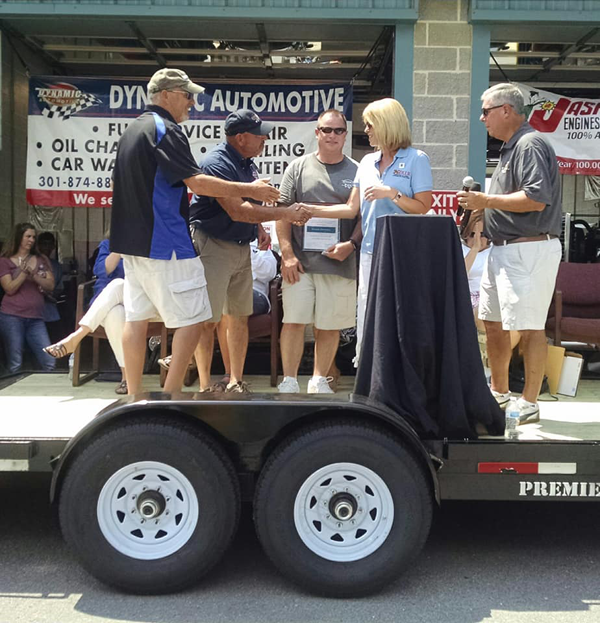 Maryland Department of Labor Secretary Kelly M. Schulz presents the owners of Dynamic Auto with a Maryland Apprenticeship Ambassador Certificate at Dynamic's 10th Annual Benefit Car Show in Frederick, MD. Photo credit: Frederick.com