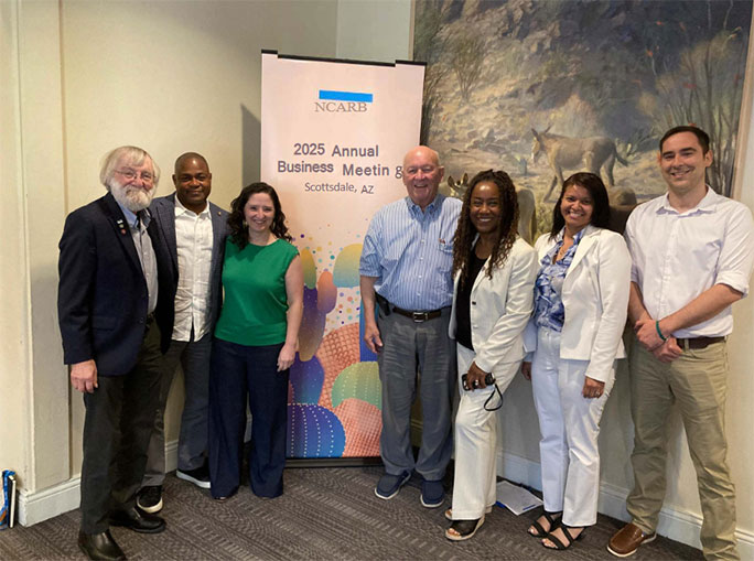 Seven board members stand in front of a NCARB sign at the NCARB conference in Scottsdale Arizona in 2025