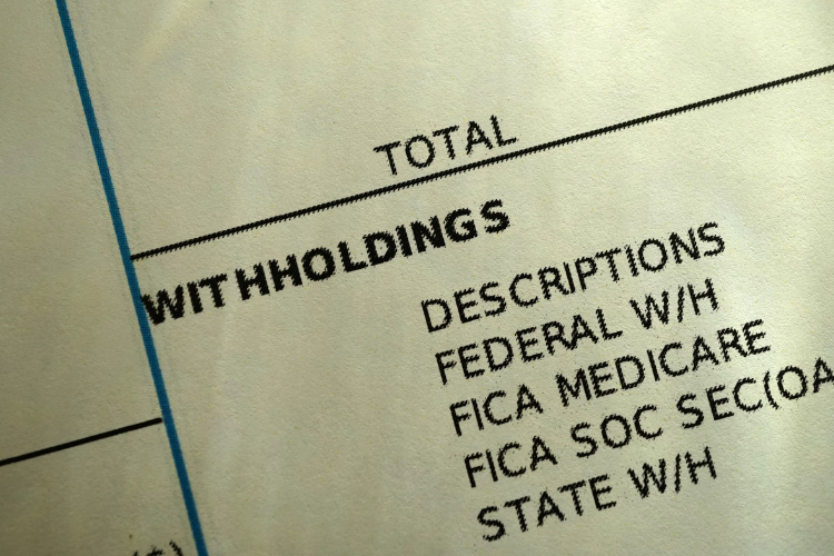Close-up of a pay statement with types of withholding listed.