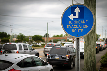 Hurricane evacuation route sign with traffic in the background
