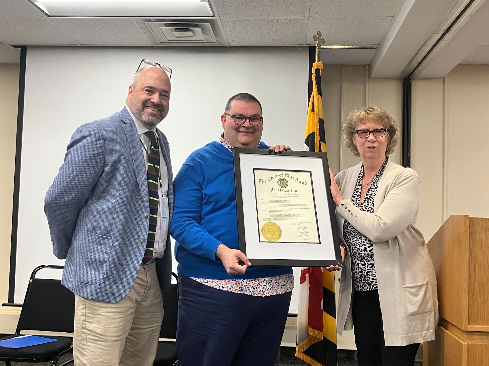 Maryland Department of Labor Deputy Secretary Jason Perkins-Cohen, Maryland Department of Health Developmental Disabilities Administration Director of Programs Nick Burton and Maryland Department of Disabilities Secretary Carol Beatty, thank 31 direct support professional honorees for their service at 100 Community Place in Crownsville, MD.