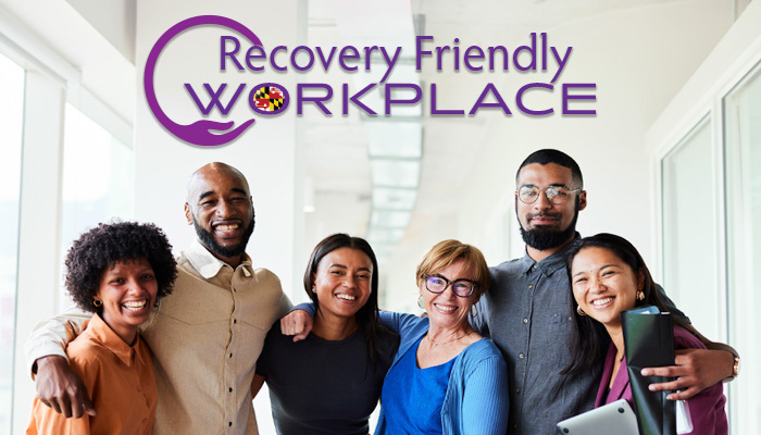 recovery friendly workplace logo and 6 workers stand in an office