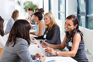 people attending a job fair. woman talks to recruiter