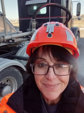 Jessica stands outside next to a truck