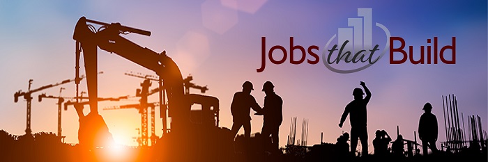 Image of a group of workers in hard hats working outside next to construction equipment 